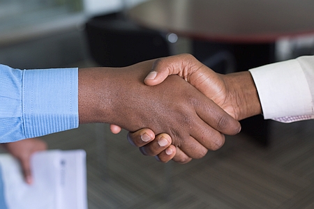 Facilities professionals shaking hands